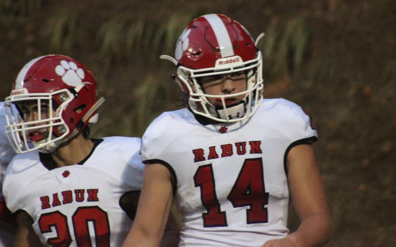 Rabun County wide receiver Sutton Jones (20) and quarterback Gunner Stockton walk back to the sideline after Stockton ran for a  touchdown during the second half against Monticello in Monticello last Friday night. (Glendon Poe/The Clayton Tribune)