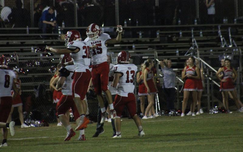 Rabun County linebacker Hoff Windham (30) celebrates with wide receiver Sam Adams after Windham recovered a Monticello fumble during the first half in Monticello last Friday night. (Glendon Poe/The Clayton Tribune)