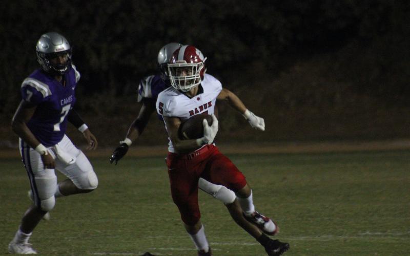 Rabun County wide receiver Hogan Woodard (5) returns a punt, while Monticello quarterback Keyshawn Ammons (7) and other teammates pursue during the second half in Monticello last Friday night. (Glendon Poe/The Clayton Tribune)
