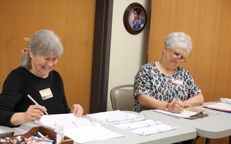 Annabelle Barkman, left, and Jan Timms check people in and verify voter registrations for residents who participate in early voting at the Rabun County Board of Elections Office on Monday. Early voting ends Friday, Nov. 1.