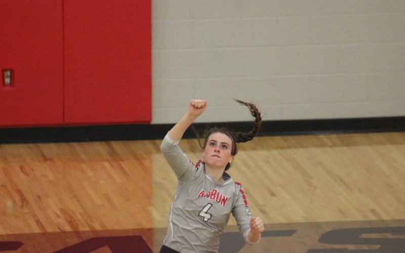 Rabun County’s Abbye Carver watches her serve attempt during a match against Armuchee during the the first round of the GHSA Class A/AA-Public state playoffs in Tiger last Saturday. (Glendon Poe/The Clayton Tribune)
