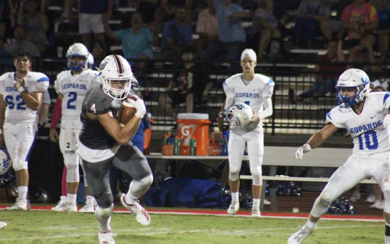 Rabun County wide receiver Braxton Hicks (4) cuts right and looks for additional running room after catching a pass during the second half against Banks County at Frank Snyder Memorial Stadium in Tiger last Friday night. (Glendon Poe/The Clayton Tribune)