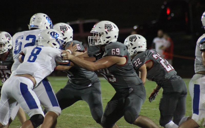 Rabun County defensive linemen Will Hightower (6) and Brock Thompson (69) and cornerback Hunter Moore (22) work against Banks County offensive linemen at Frank Snyder Memorial Stadium in Tiger on Oct. 4. (Glendon Poe/The Clayton Tribune)