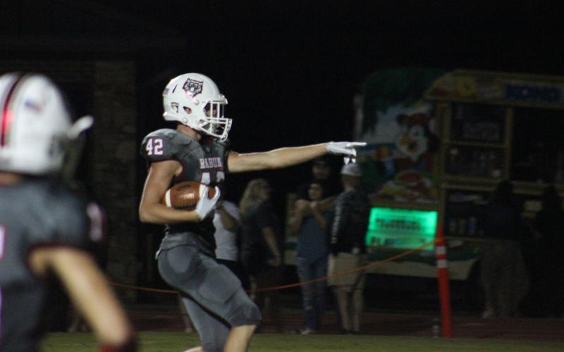 Rabun County running back Cory Keller points to the student section after crossing the goal line during the second half against Banks County at Frank Snyder Memorial Stadium in Tiger last Friday night. (Glendon Poe/The Clayton Tribune)