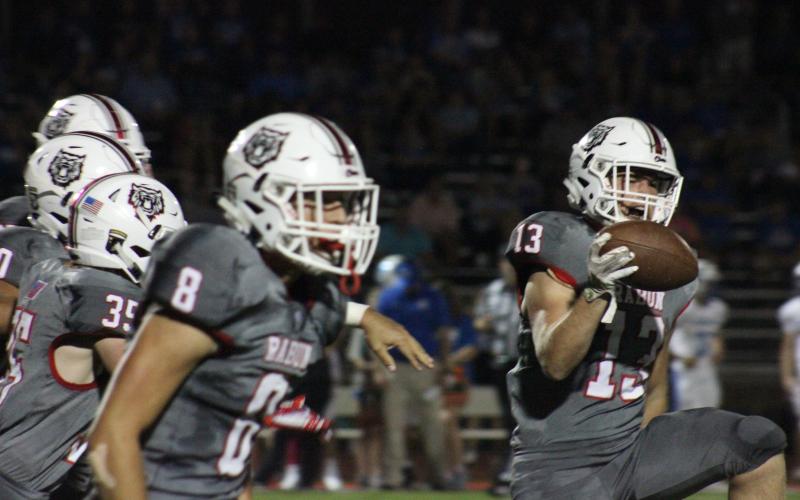 Rabun County linebacker Brody Jarrard (13), safety Garrett Bragg (8) and other teammates celebrate after recovering a fumble during the first half against Banks County at Frank Snyder Memorial  Stadium in Tiger last Friday night. (Glendon Poe/The Clayton Tribune)