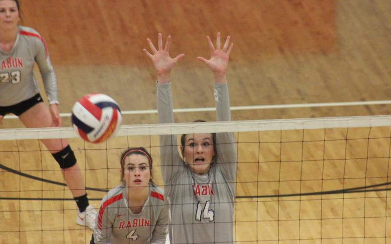 Rabun County’s Gracie Deetz (14) attempts to block a shot, while teammate Abbye Carver watches during a match against Dade County in the quarterfinal round of the GHSA Class A/AA-Public state playoffs at Ken Byrd Court in Tiger last Saturday afternoon. (Glendon Poe/The Clayton Tribune)