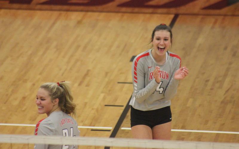 Rabun County’s Beth Payne, left, and Gracie Deetz celebrate after winning a set against Armuchee during the first round of the GHSA Class A/AA-Public state playoffs in Tiger last Saturday. (Glendon Poe/The Clayton Tribune)