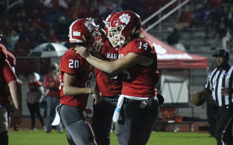 Rabun County wide receiver Sutton Jones (20) is congratulated by quarterback Gunner Stockton (14) and other teammates after making a touchdown catch during the first half against Social Circle at Frank Snyder Memorial Stadium in Tiger last Friday night. (Glendon Poe/The Clayton Tribune)