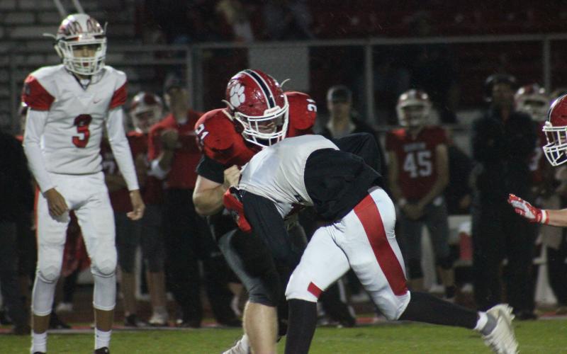 Rabun County defensive lineman Phillip Roberson (21) tackles Social Circle running back Amarion Russell during the first half at Frank Snyder Memorial Stadium in Tiger last Friday night. (Glendon Poe/The Clayton Tribune)