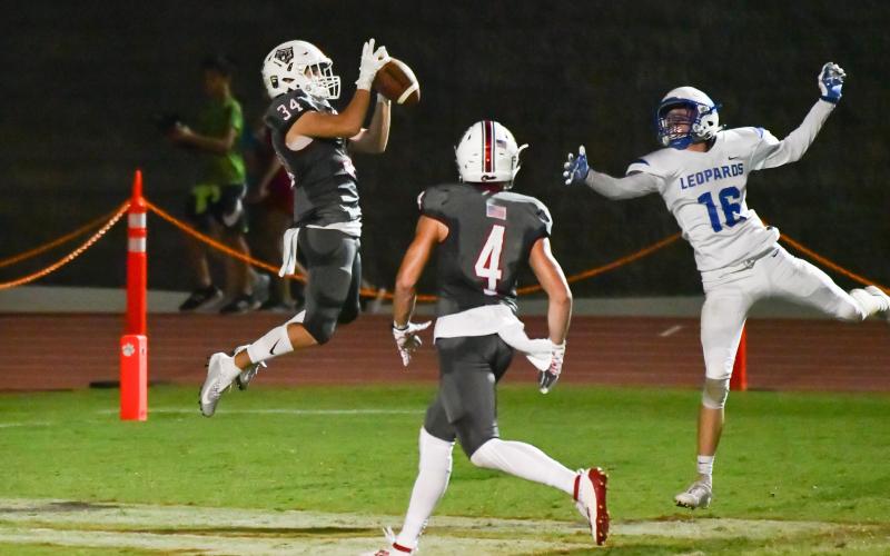 Rabun County wide receiver Tate Ramey (34) catches a pass while teammate Braxton Hicks watches during a game against Banks County at Frank Snyder Memorial Stadium in Tiger on Oct. 4. (Scott Poss/Special to The Tribune)