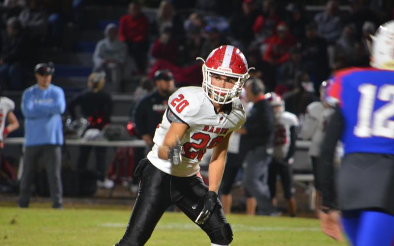 Wayne Knuckles/The Clayton Tribune. Junior wide receiver Sutton Jones (20) checks his spot with the referee against Oglethorpe last Friday night.