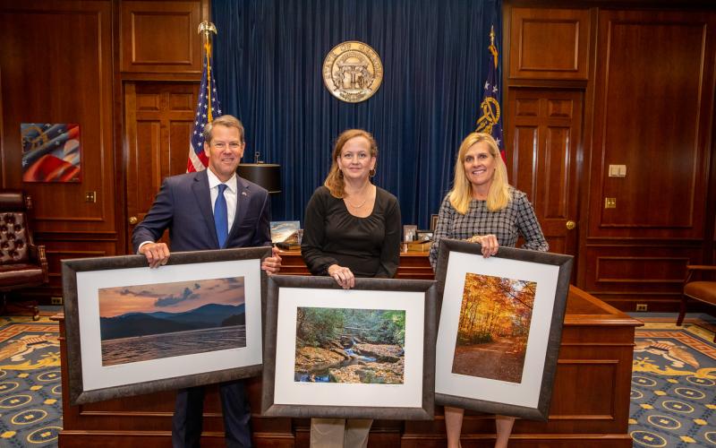 Rabun County photographer Michele Crawford, center, with Gov. and Mrs. Brian Kemp.