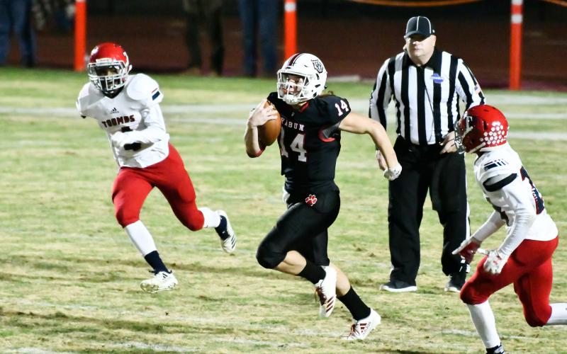 Scott Poss/The Clayton Tribune. Gunner Stockton scrambles against Toombs County Friday night.