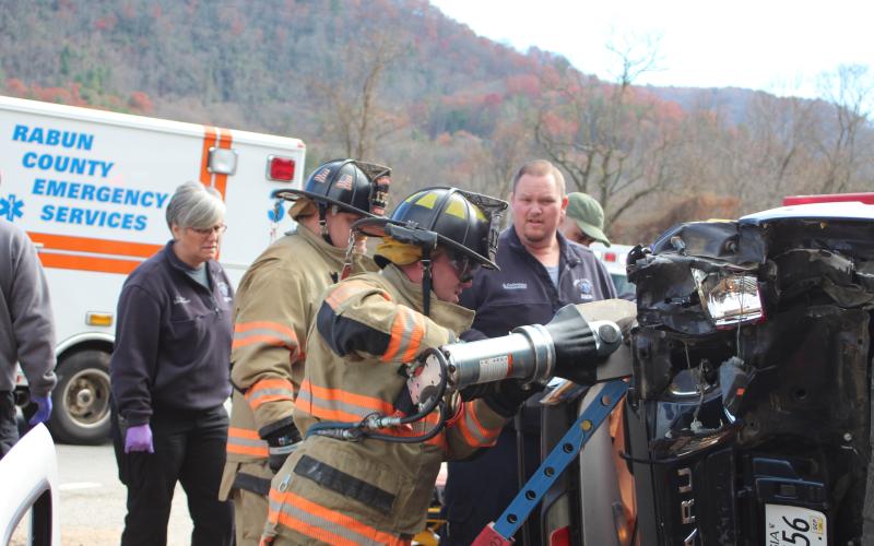 Megan Broome/The Clayton Tribune. Emergency personnel work to free an occupant trapped in a vehicle after it rolled over from a crash in Mountain City on Thursday, Nov. 21 at approximately 12:36 p.m.