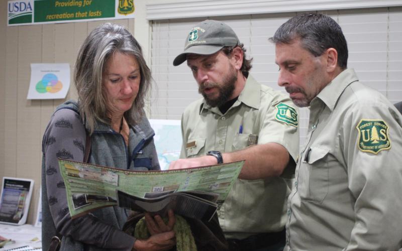 Megan Broome/The Clayton Tribune. Terri Jagger Blincoe, left, discusses the United States Forest Service Foothills Landscape Project with Phillip Waldrop, United States Forest Service, and Derek Fusco, Chattahoochee-Oconee National Forests.