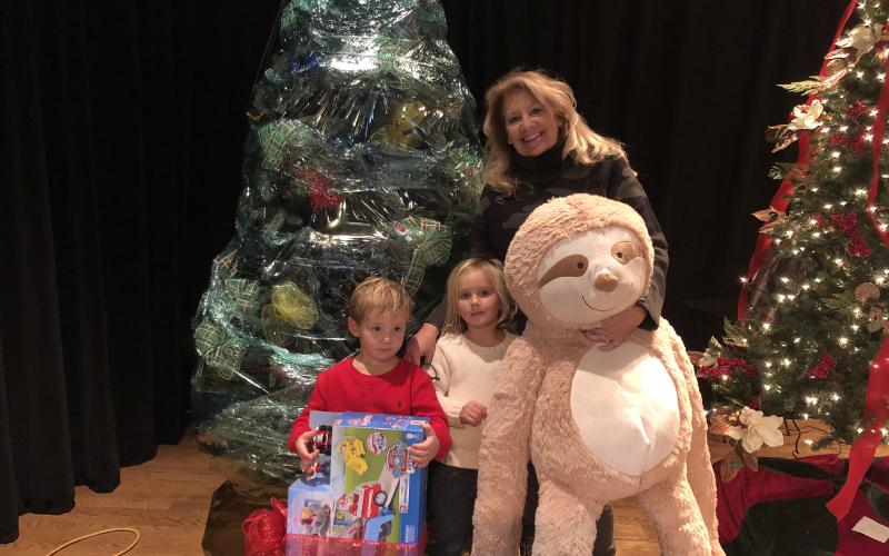 Shelly Lapp and her grand kids, Olivia and Riggs Bakes pack up their Christmas tree after winning the silent auction