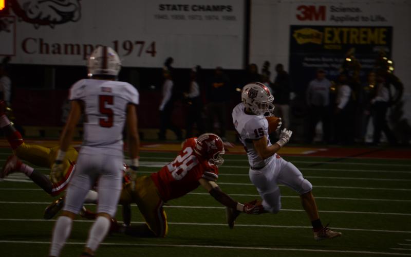 Wayne Knuckles/The Clayton Tribune. Senior Sam Adams (15) eludes a Thomasville defender Friday night.