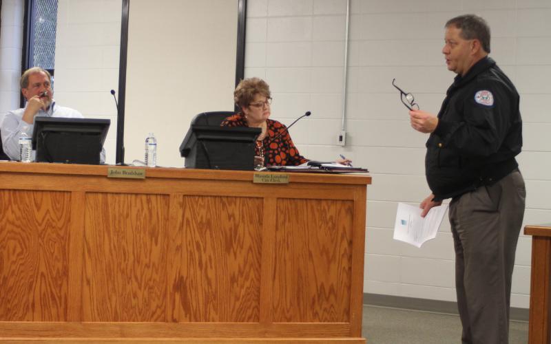 Megan Broome/The Clayton Tribune. Brendan Thompson, right, general manager for the Rabun County Water and Sewer Authority, discusses a partially unpaid August 2019 water bill for the city of Clayton with Council Members at their meeting on Tuesday.