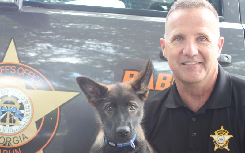 Megan Broome/The Clayton Tribune. Detective John Murphy was recently named the Rabun County Sheriff’s Office Deputy of the Year. He poses with K9-in-training German Shepherd puppy Koa when he was 15 weeks old. Murphy said that he is honored to receive the award.