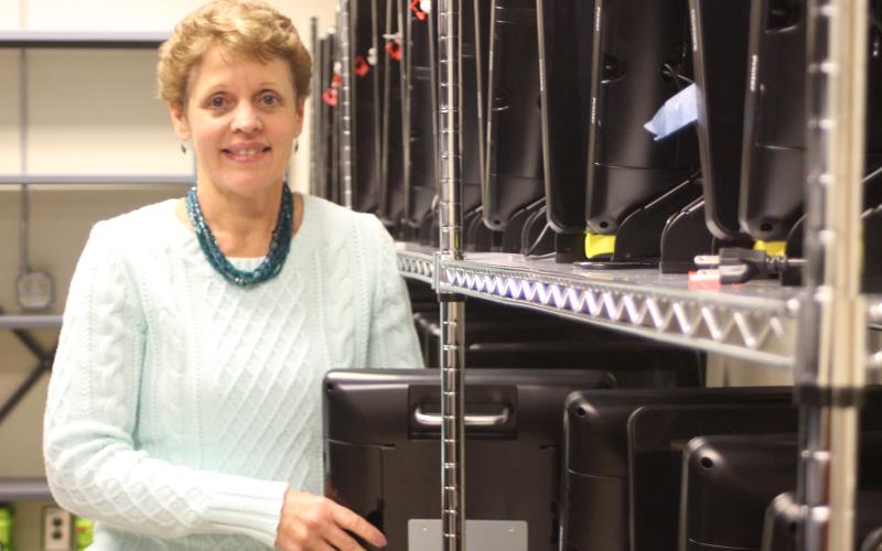 Megan Broome/The Clayton Tribune. Kay Townsend stands in front of the new election equipment that Georgia voters will use when they head to the polls for 2020 elections.