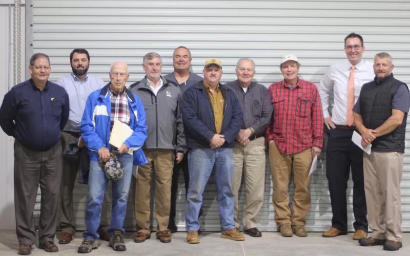 Megan Broome/The Clayton Tribune. Brendan Thompson, general manager for the RCWSA, left, Claude Rickman, Dallas Taylor, Greg Peters, vice-chairman, Kent Woerner, County Commissioner, Roger Mullins, Jerry Krivsky, Jeff Hunter, Brett Cohee, and Darrin Giles, county administrator, stand inside their new office-shop building located on Yorkhouse Rd. in Rabun Gap.
