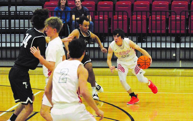 Matthew Osborne/The Northeast Georgian. Rabun County's Grayson Carver (30) looks to drive on Tallulah Falls defender Winston Davis during Friday's game.