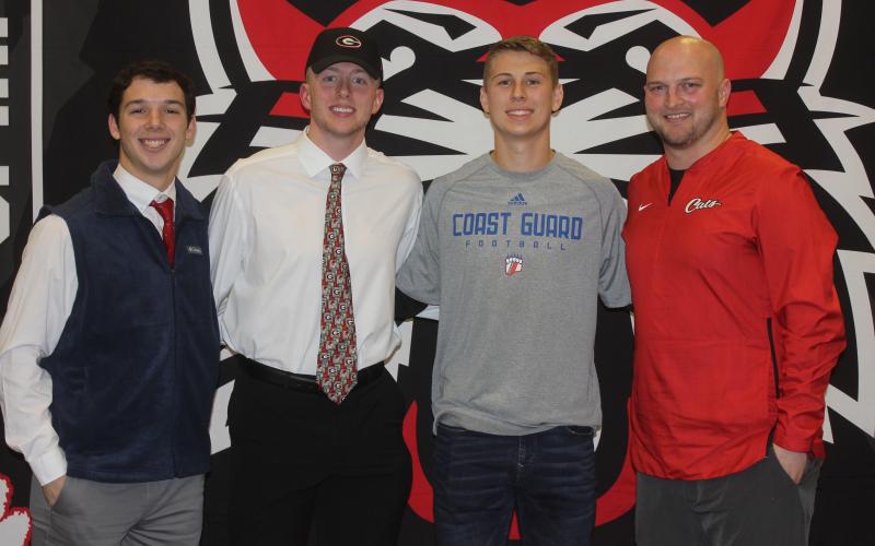 Andy Diffenderfer/The Clayton Tribune From left are Sam Adams, Braxton Hicks, Garrett Bragg and Rabun County High head football coach Jaybo Shaw on National Signing Day Feb. 5 at the school.