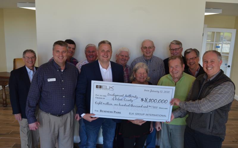 Wayne Knuckles/The Clayton Tribune Development Authority of Rabun County board members marked the completion of the sale of the former Fruit of the Loom building to ELK International for $8.1 million Monday. From left are: Janney Sanders (DARC attorney), Claude Dillard (DARC chairman0, John Dillard, Greg Brown, Todd Webb, ELK Group International COO, Jim Bleckley, Leckie Stack, Elliott Keller, Bob Fink, Pete Halter, Robert Pittman and Rick Story, Director of Development for Rabun County.