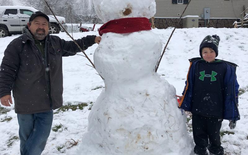 Submitted Photo Colton Richardson, 7, made a snowman with  his grandfather David Collins in Clayton.