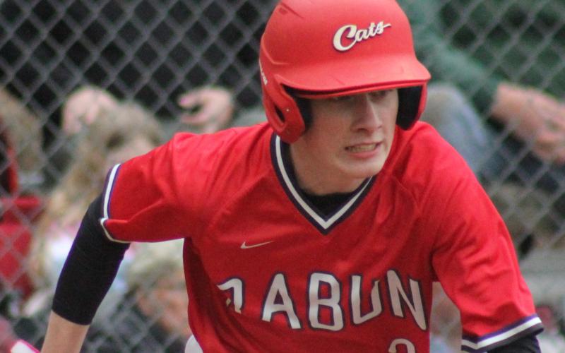 Andy Diffenderfer/The Clayton Tribune Rabun County High baseball player Grayson Carver heads to first base in a recent game. Thanks to COVID-19, RCHS, Tallulah Falls and Rabun Gap-Nacoochee are sidelining spring sports.