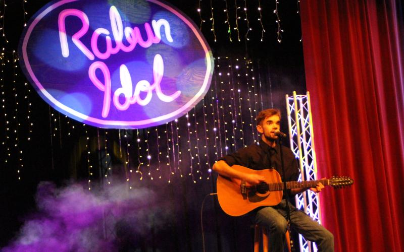 Megan Broome/The Clayton Tribune. Garrison Matlock plays the guitar and sings “Ring of Fire” for his final solo performance.