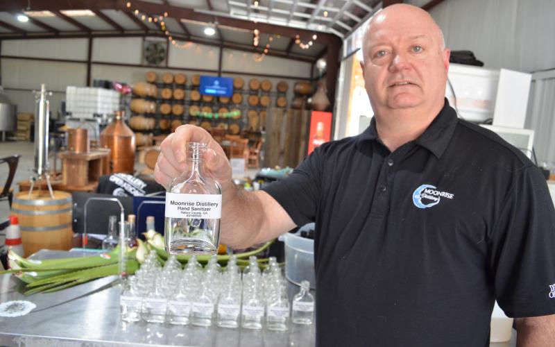 Wayne Knuckles/The Clayton Tribune. Moonrise Distillery in Clayton was one of the first craft distilleries in the nation to convert production to hand sanitizer during the COVID-19 health emergency. Owner Doug Nassaur said Moonrise will continue to make bottles of sanitizer available to local residents as long as it is possible to do so.