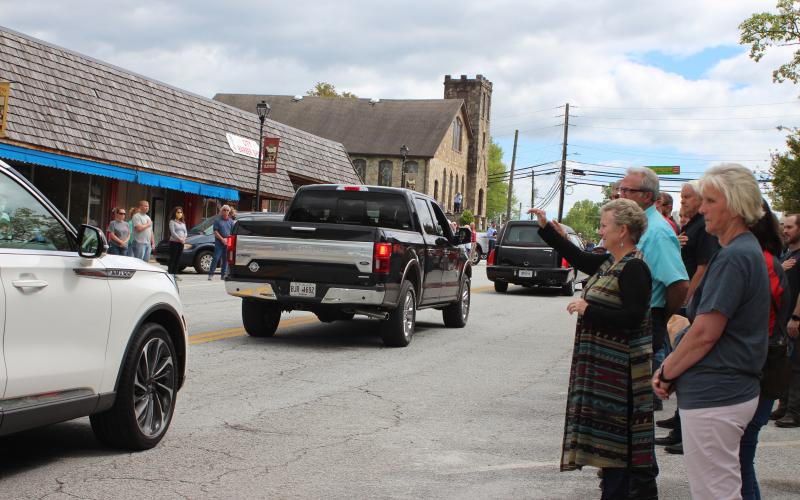 Megan Broome/The Clayton Tribune. Reeves Hardware employees were joined by community members in paying their respects and showing their support to the family of Carol Watts Reeves as her funeral procession passed by Reeves Hardware in Clayton Friday, April 24.
