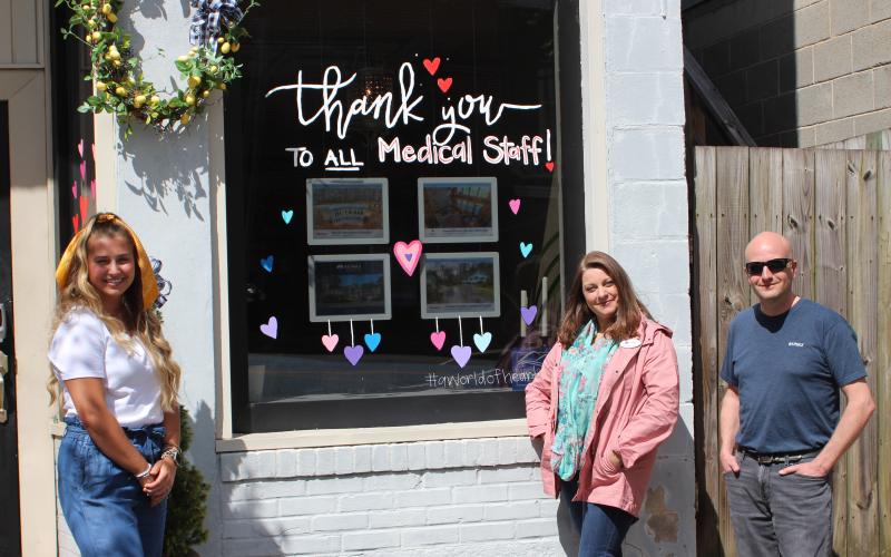 Megan Broome/The Clayton Tribune. Artist Ali Wilkins, left, with Tambrie Kitchens and Jon Barnwell of Re/Max Town and Country of Rabun.