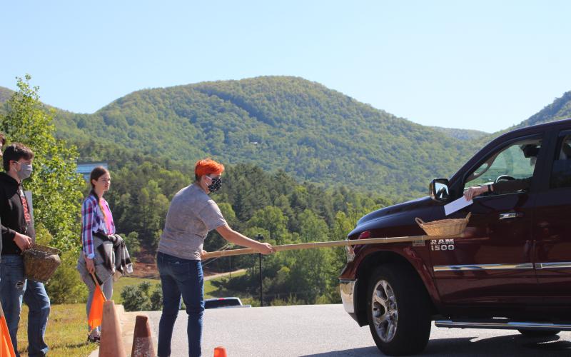 Megan Broome/The Clayton Tribune.Peyton Fisher, left, Heidi Gardner and Jalyn Fisher collect offerings as churchgoers of Clayton First United Methodist Church leave following the first drive-in church service held on Ministry Mountain on Sunday.