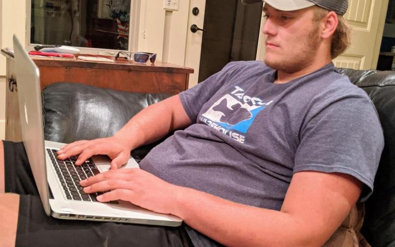 Photo courtesy Bear Old. Bear Old works on his assignments online as Rabun County Schools moved to at-home learning due to the COVID-19 pandemic.