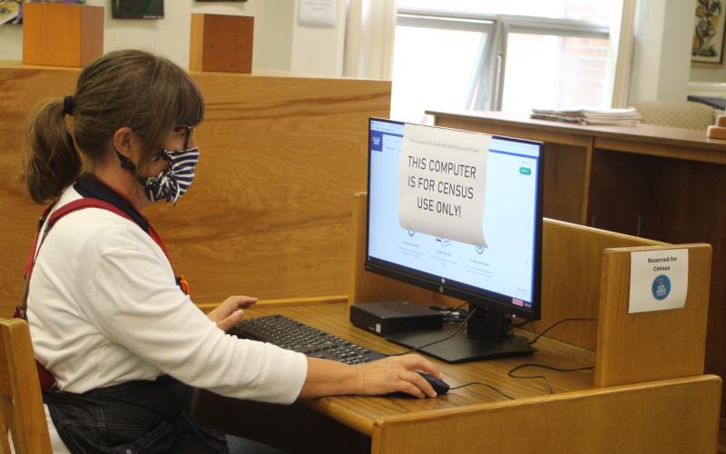 Megan Broome/The Clayton Tribune. Caroline Frick, library manager, sits atone of the three computers designated for use to complete the 2020 Census. The computers were purchased by the United States Census Bureau and will be donated to the library once the count is completed.