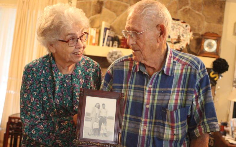 Megan Broome/The Clayton Tribune. Clara and Earl Zoellner of Dillard celebrated their 75th wedding anniversary this week. They were married in 1945 in Clarkesville. Above, the couple holds a picture of themselves with their children, Stanley and Gail, when they were young.