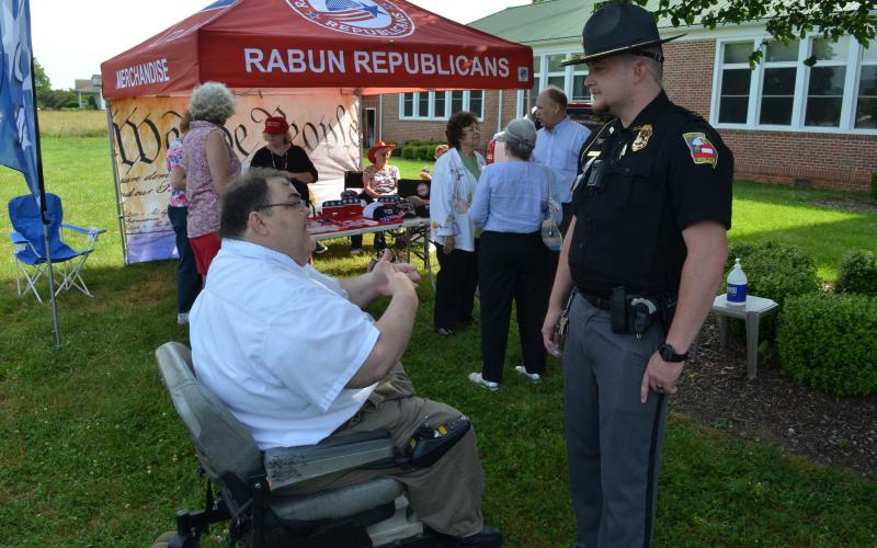 Wayne Knuckles/The Clayton Tribune. Ed Henderson, left, secretary of the Rabun County Republican Party, talks with Dillard Police Chief Jeremy Parker Saturday morning.