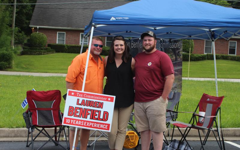 Megan Broome/The Clayton Tribune. Brian Talley, left, Candidate Lauren Benfield and Jordan Benfield camp out in the parking lot across from the Civid Civic Center and spend Tuesday greeting voters as they head to the polls for the primary election.