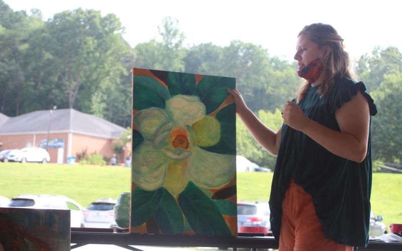 Megan Broome/The Clayton Tribune. Sarah Decker, 2020 graduate of Rabun County High School, presents her future plans and discusses the inspiration behind her artwork to the North Georgia Arts Guild at their meeting last Thursday.