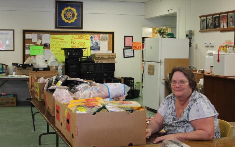 Megan Broome/The Clayton Tribune. Annie Heffelfinger volunteers at the American Legion Post 220 food distribution, which is held every Thursday.
