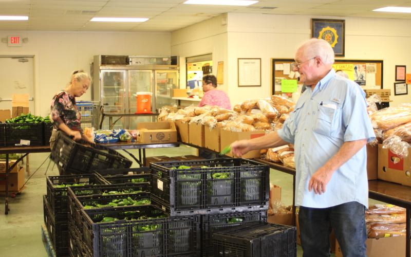 Megan Broome/The Clayton Tribune. Carl Green works to move boxes and organize food to be distributed to residents of the community at the American Legion Post 220 food distribution last Thursday.