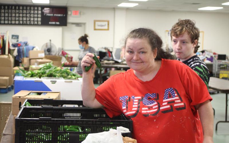 Megan Broome/The Clayton Tribune. Patricia Simonds browses food tables at the American Legion Post 220 food distribution last Thursday.