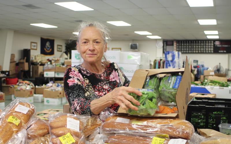 Megan Broome/The Clayton Tribune. Ursula Vicari browses food tables at the American Legion Post 220 food distribution last Thursday.