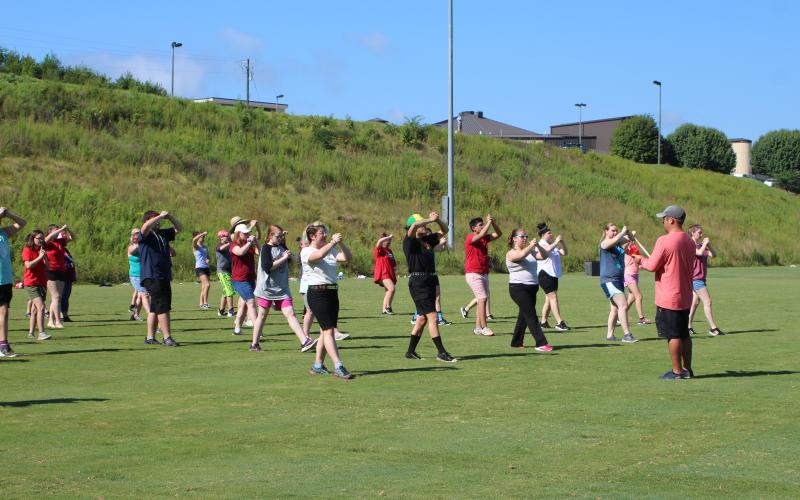 Rebekah Ramey, left, Randall Ramey, Megan Page and Sarah Abernathy work on marching fundamentals on the practice field at Rabun County High School at band camp last week.
