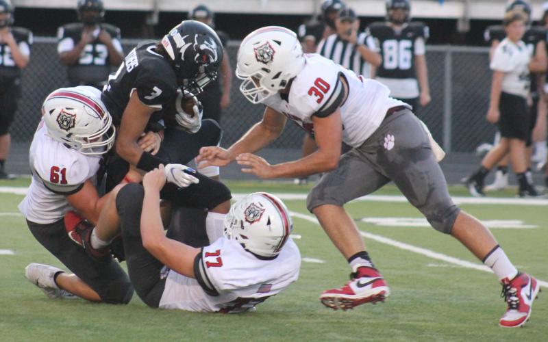 Andy Diffenderfer/The Clayton Tribune. Ridgeland running back KeSean Eubanks goes nowhere as Wildcat defenders Will McCraw, Chris Thompson and Hoff Windham pounce last Friday in Rossville.