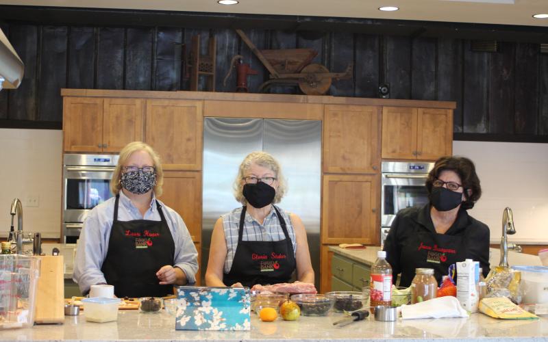 Megan Broome/The Clayton Tribune. Laura Hunter, left, Gloria Stokes and Joanne Baumgartmner are volunteers in the Food Bank of Northeast Georgia Teaching Kitchen and have stayed as they'e seen three teaching kitchen managers come and go. They say their passion for food, camaraderie and the community are what inspire them to volunteer.