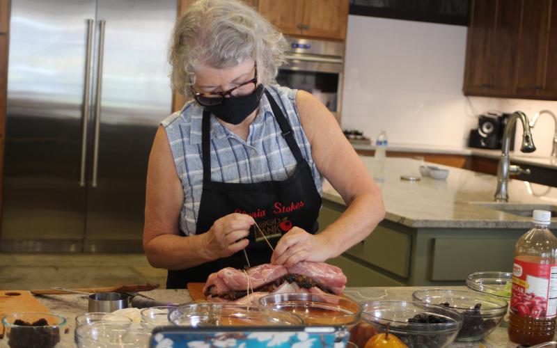 Megan Broome/The Clayton Tribune. Gloria Stokes prepares a dish at the Food Bank Teaching Kitchen Monday.