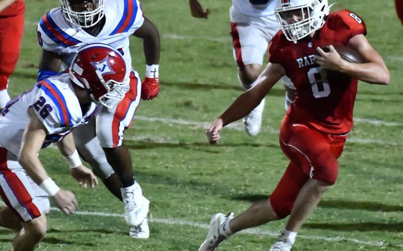 Photo courtesy of Scott Poss. The Wildcats’ Cory Keller swerves to avoid a Jefferson tackler.